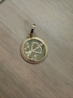 Miranda Frye gold bow & arrow charm